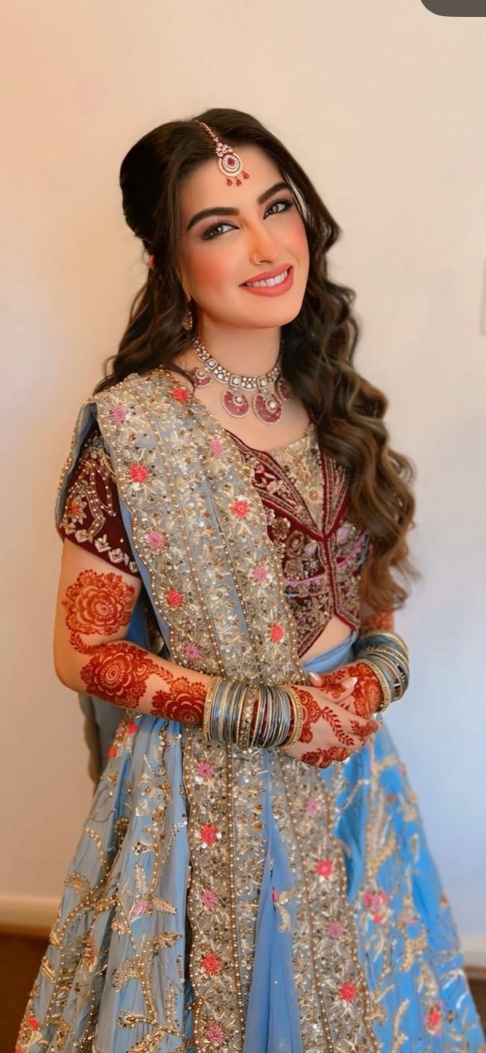 Bridal makeup, hair and mehndi in a blue lehenga by Makeup by Nidari, Houston